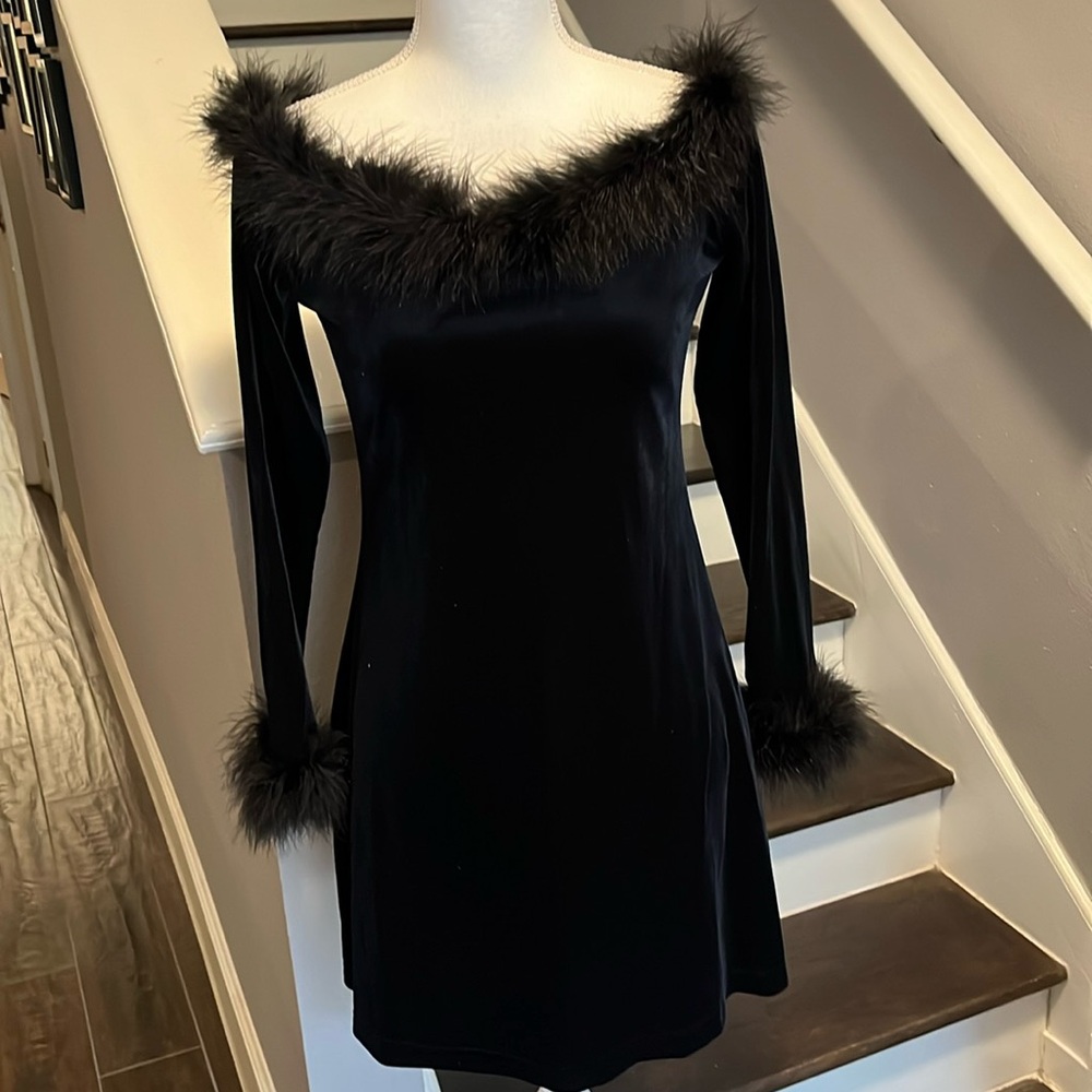 Carabella Black Dress. Scoop neckline trimmed in feathers. Long sleeves feathers